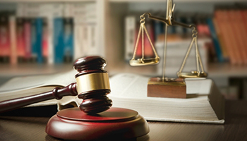 A gavel and law books on a table